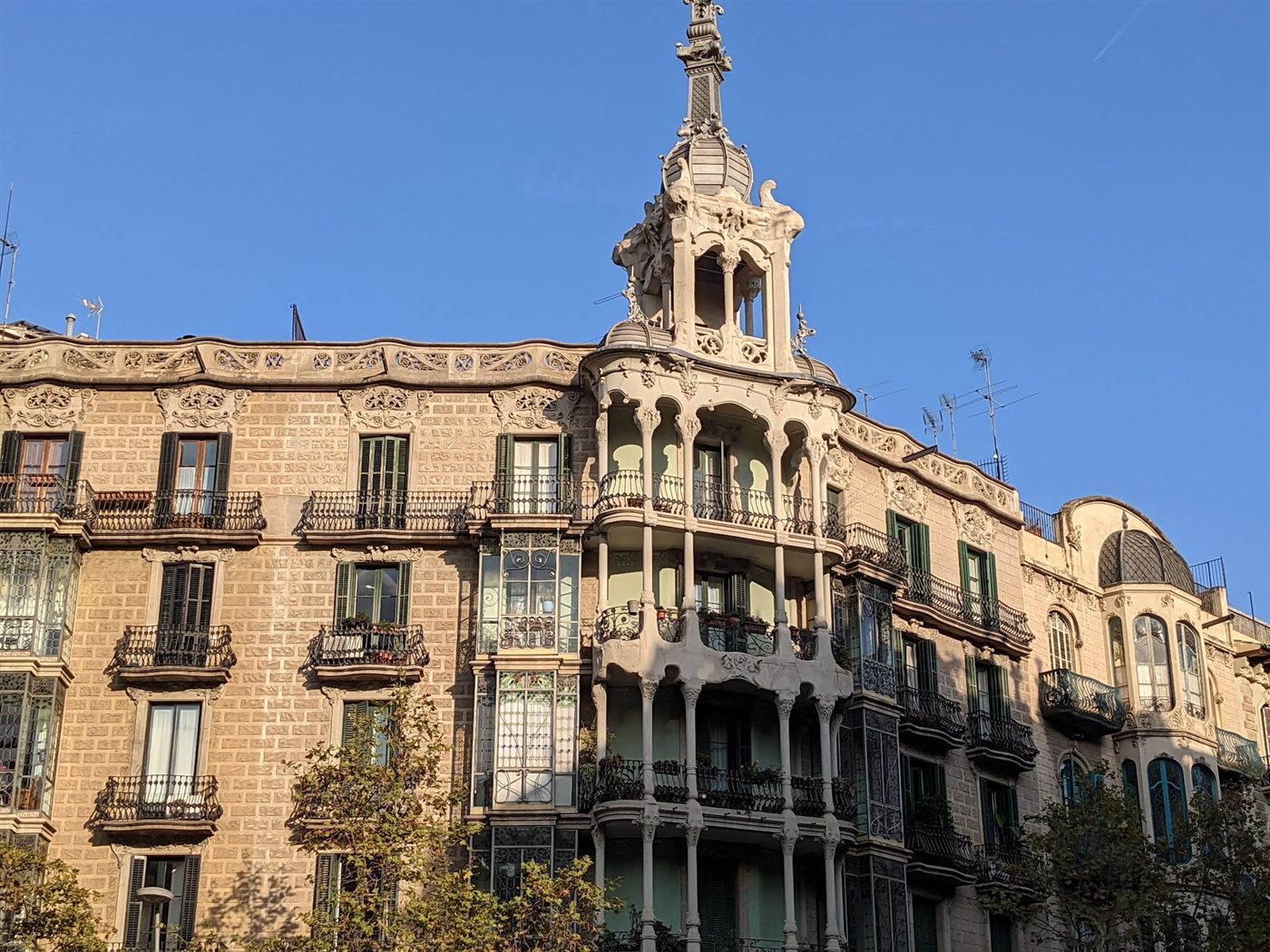 Lacy Modernista tower of stacked balconies and wrought-iron railings on a Barcelona apartment building