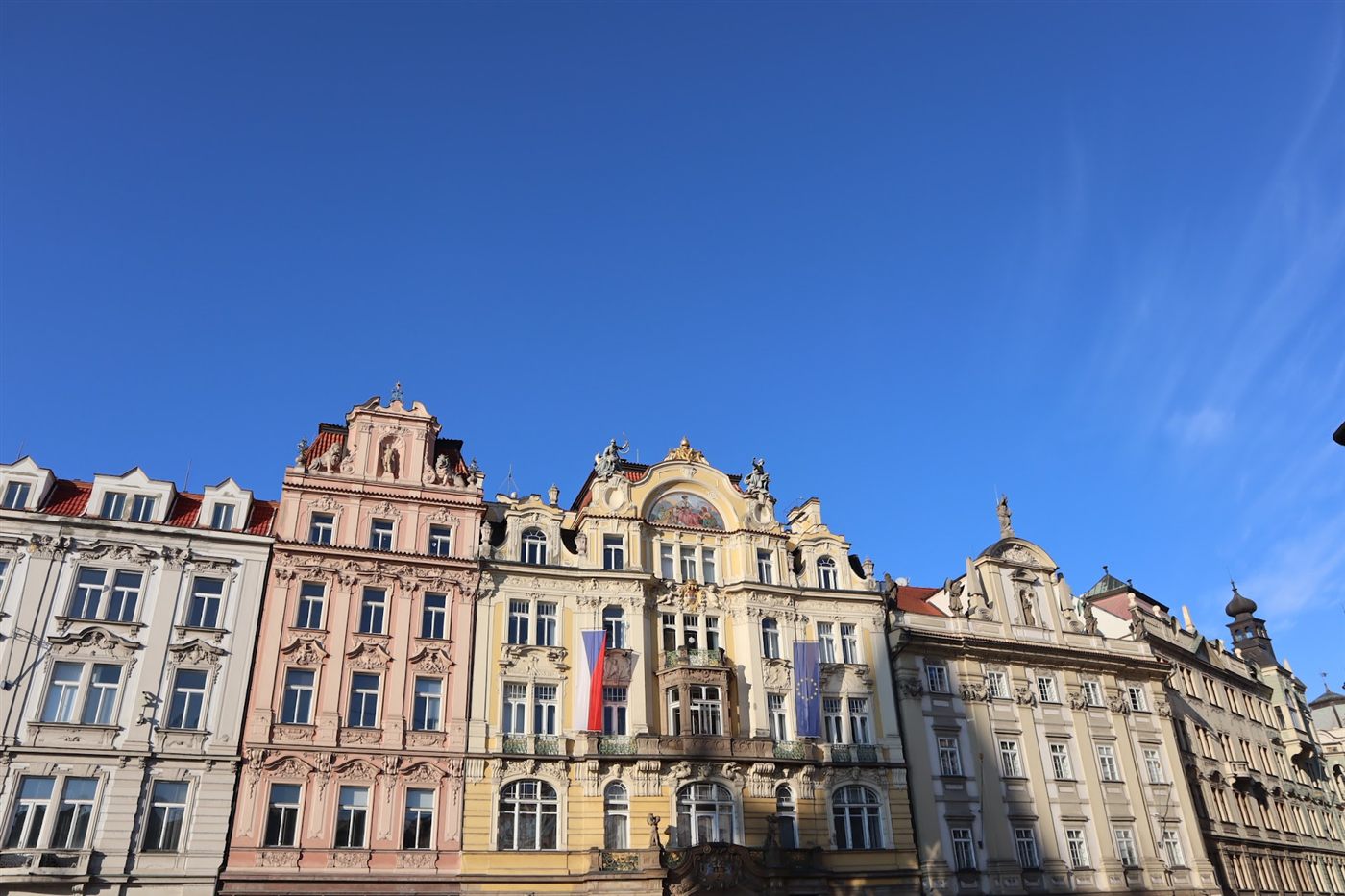 Pastel baroque facades lining a square in Prague's Old Town