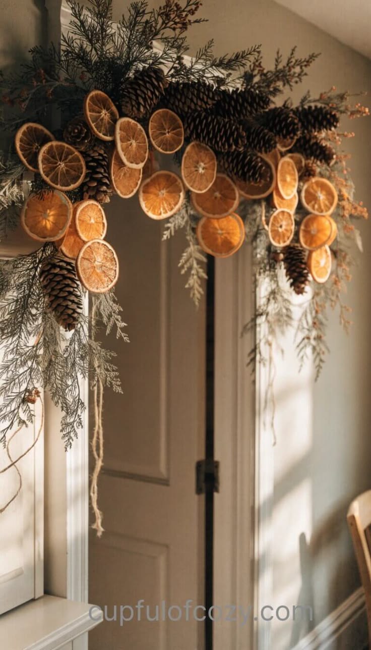 A garland of dried orange slices, pinecones and evergreen draped over a doorway