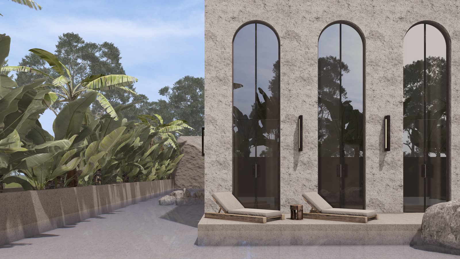 The Arches: tall arched windows in a stone wall with loungers and tropical planting