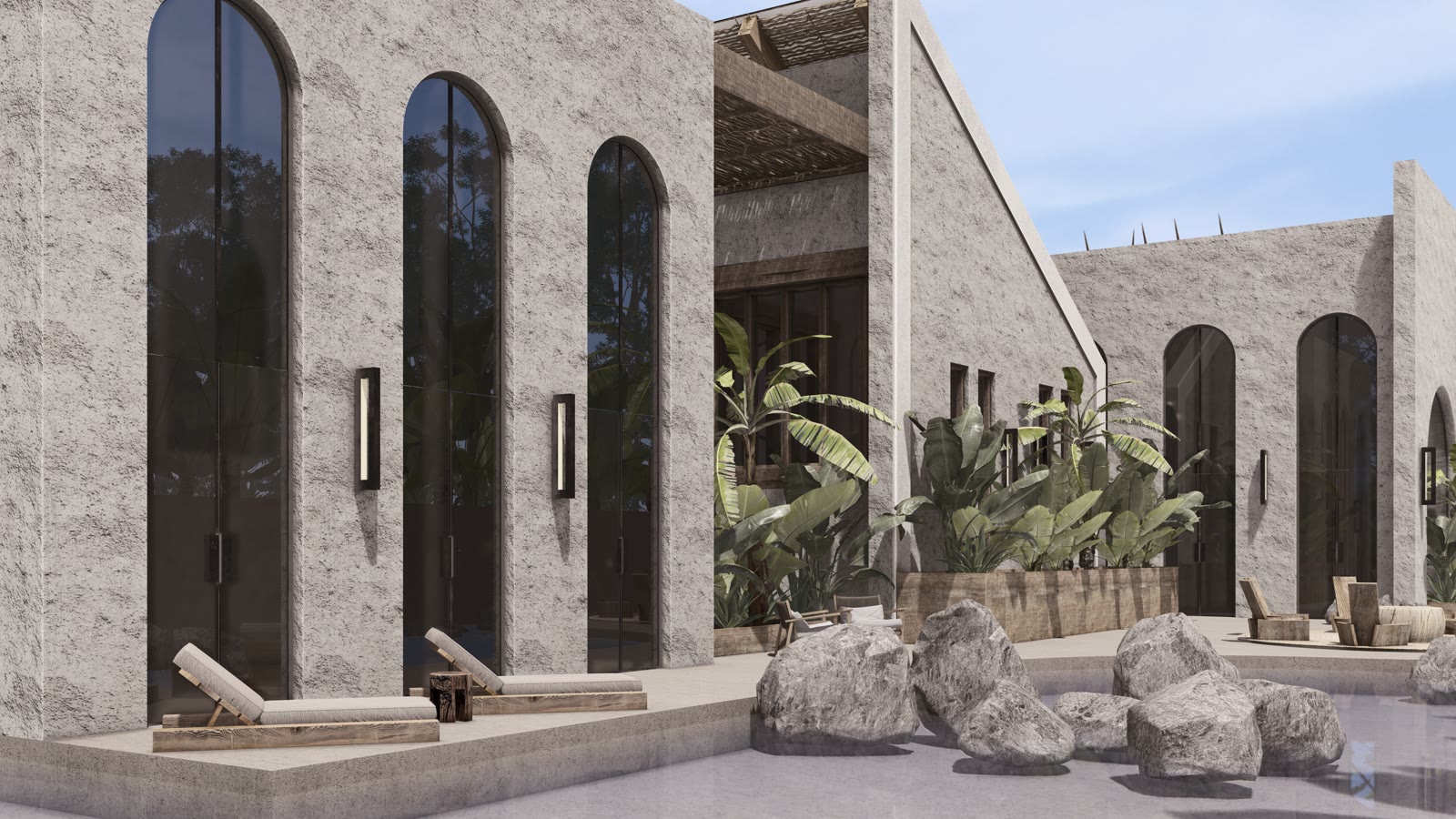 The Arches: a stone facade with tall arched windows and boulders